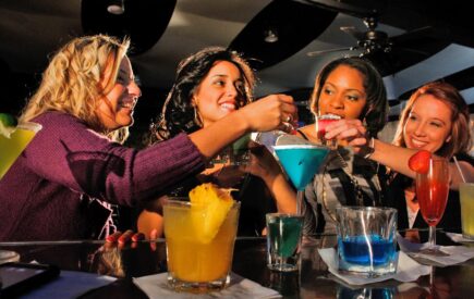 Group of bridesmaids enjoying a cocktail workshop during a bachelorette party.