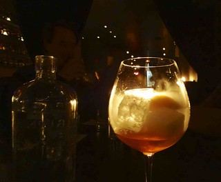 A close-up of a cocktail made with molecular mixology techniques, featuring vibrant colors and unique presentation.