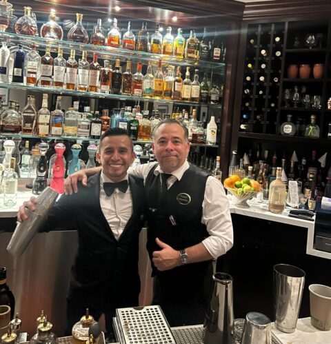 "Alam, a bartender at Aqualina Miami Beach and graduate of 786 Bartend Bartending School, mixing cocktails at the bar at a recognized 5-star establishment and lively establishment."