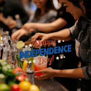 "An interactive Independence Day cocktail class at 786 Bartend, The Bartenders Institute in Miami, with participants crafting patriotic and historical drinks led by an expert instructor."