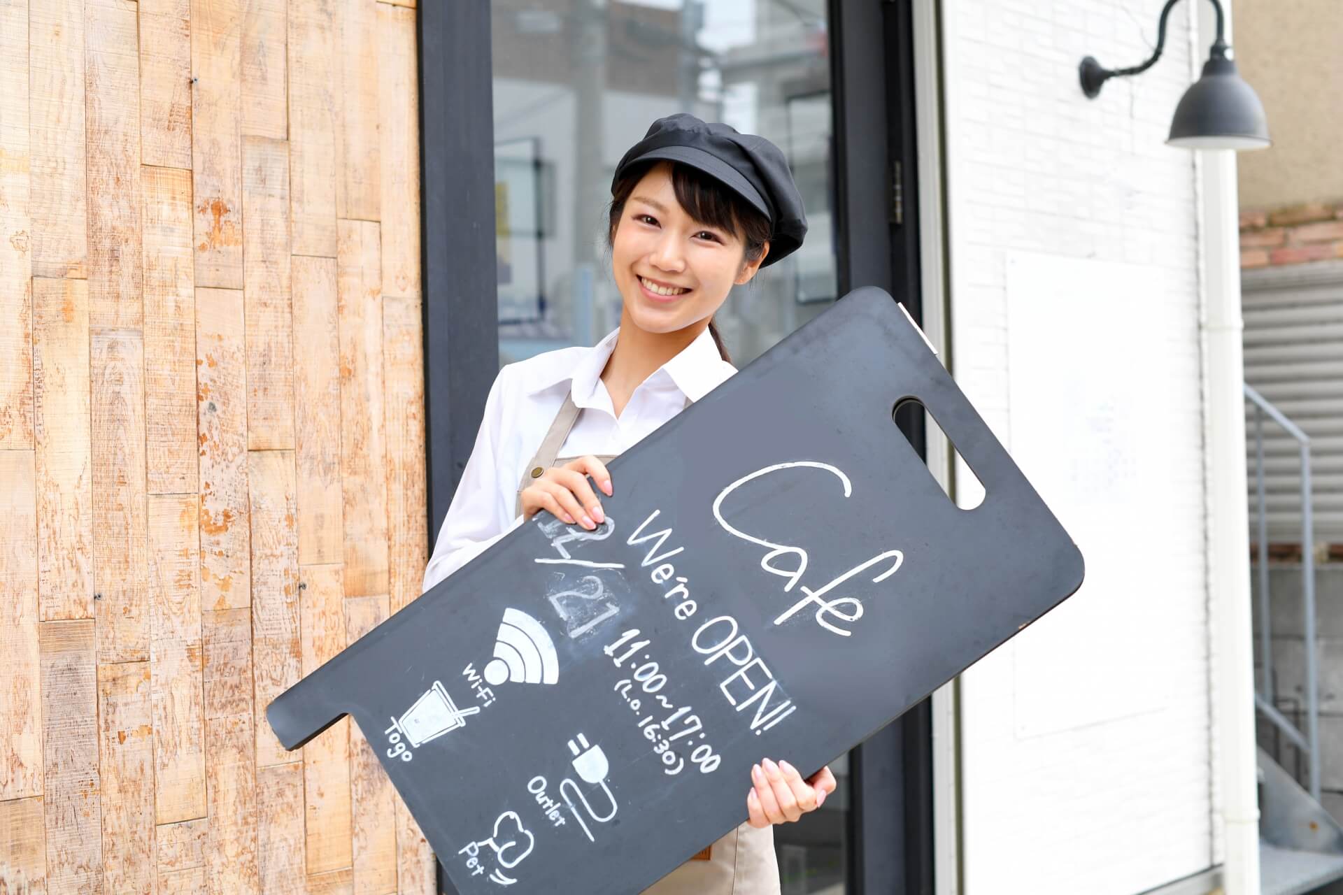 Japan woman holding a blackboard sign.