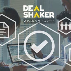 Drie mensen werken samen aan een bureau met behulp van een laptop. Zeshoekige pictogrammen, zoals checklists en groepen, worden over de scène gelegd. De tekst luidt "Dealshaker" en "2.15.06 Release Notes" om de nieuwste updates van deze dynamische release notes-omgeving te markeren.