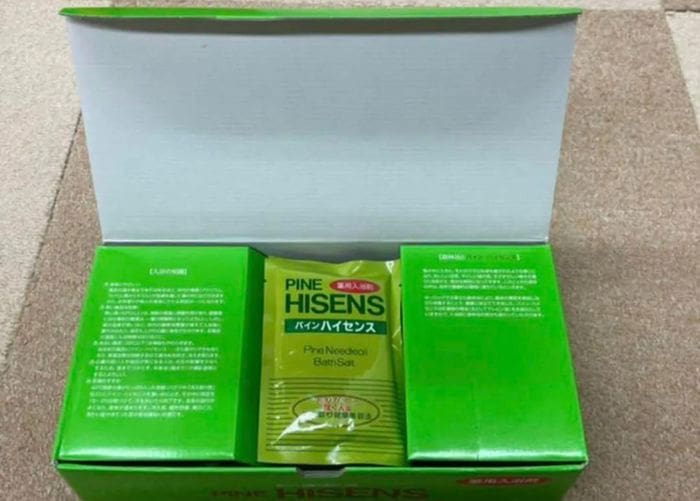 From the green box emerges a sealed package labeled "Pine Hisense" with additional text in another language. The packaging, which supposedly contains medicinal bath salts, retains the same shade, suggesting an interesting mystery in the refreshing depths.