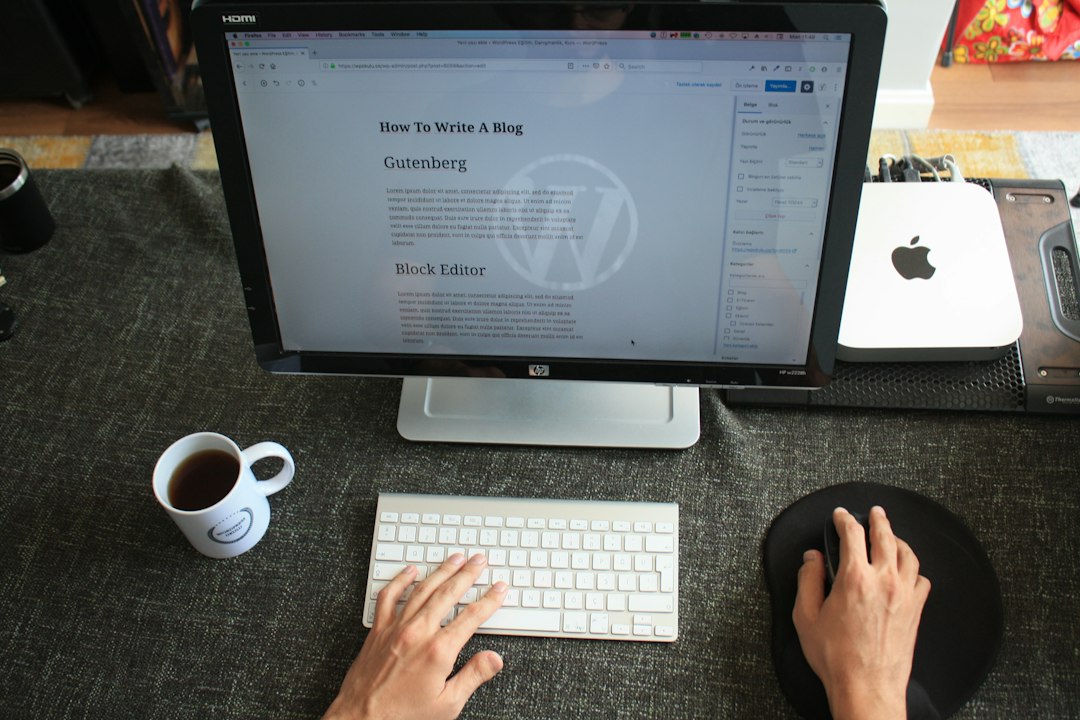 A person typing on a computer at a desk.